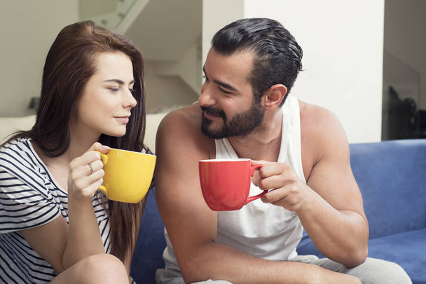 Beautiful young couple drinking coffee in the living room, Coupl - Fotoğraf, Görsel