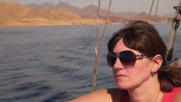 Woman sitting on the deck of the yacht - Filmati, video