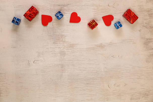 Red hearts and gift boxes on rustic wood. - Φωτογραφία, εικόνα