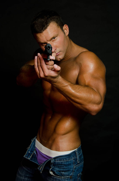 Sexy cop. Handsome man shirtless and with a gun. - Fotoğraf, Görsel