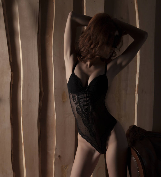 Sexy woman in black lingerie, mask and heels - Fotó, kép