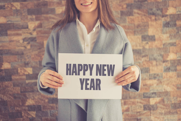 Woman presenting HAPPY NEW YEAR CONCEPT - Photo, Image