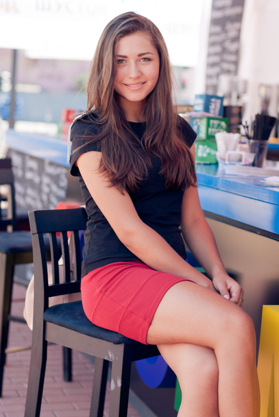 Young beautiful woman sitting at bar counter - Fotó, kép