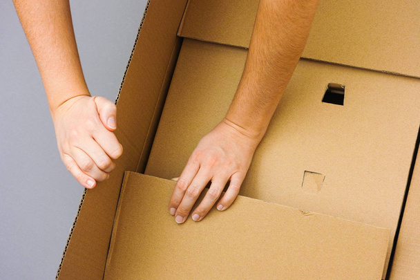 Two woman hands opening big cardboard box - Photo, Image