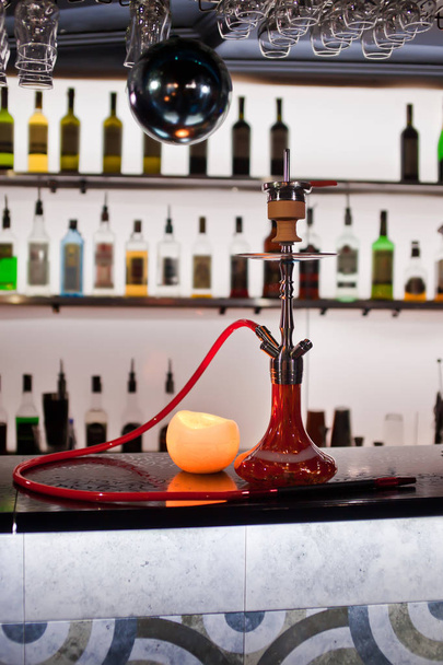 Close-up photo of red hookah on bar background - 写真・画像