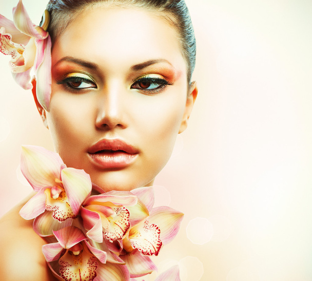 Beautiful Girl With Orchid Flowers. Beauty Woman Face - Fotó, kép