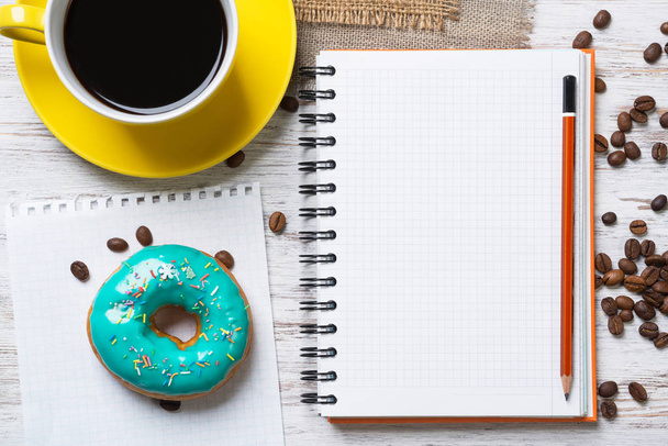 Opened notepad with donut - Photo, Image