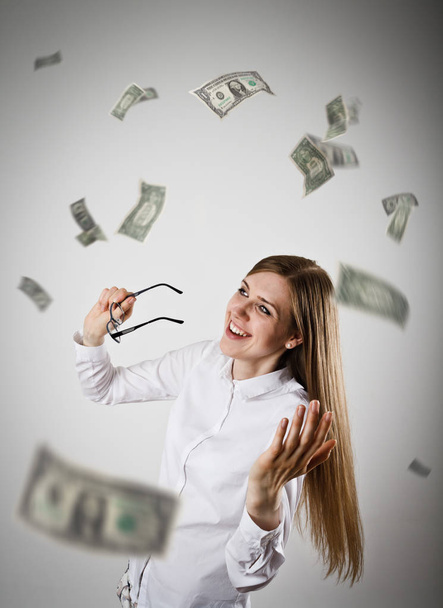Rejoicing. Woman in white and Dollars. - Foto, Imagen
