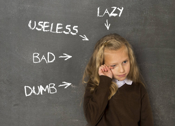 abused disciplined schoolgirl pointed as lazy dumb bad and useless on class blackboard - Photo, Image