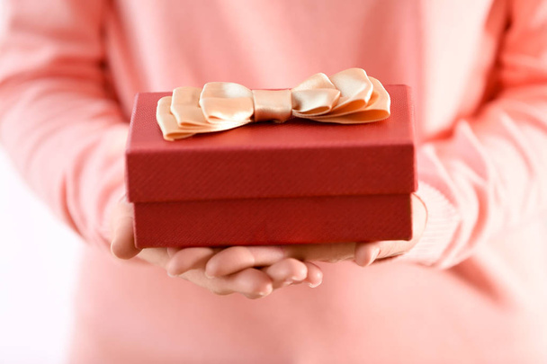 Female hands holding gift box, closeup - Фото, изображение