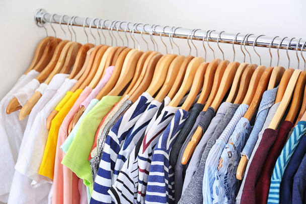 Hangers with colorful clothes on rack, closeup - Foto, Imagem