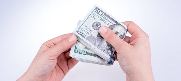 Human hand holding American dollar banknotes on white background - Foto, Imagem