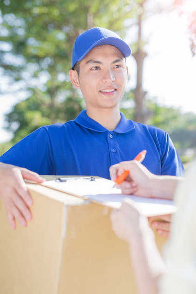 deliveryman holding box - Photo, Image