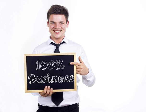 100% Бизнес - Молодой улыбчивый бизнесмен, держа в руках картонку
 - Фото, изображение