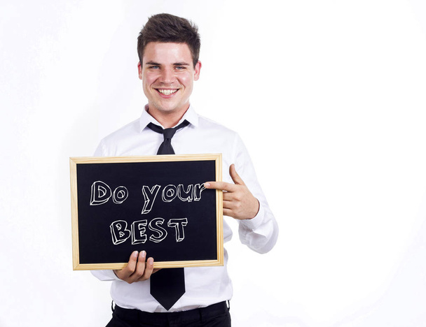 Haga su mejor esfuerzo - Joven hombre de negocios sonriente sosteniendo pizarra con
 - Foto, Imagen