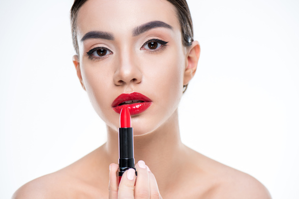 Woman holding red lipstick - Foto, afbeelding