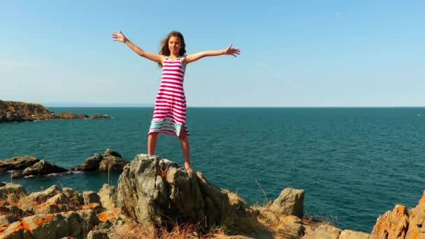 Little beautiful girl on rocky shore of Mediterranean Sea. - Footage, Video