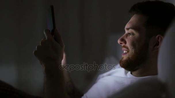 young man with tablet pc in bed at home bedroom - Filmagem, Vídeo