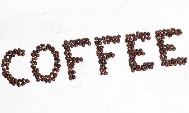 The inscription Coffee laid out of coffee beans. Isolated on whi - Φωτογραφία, εικόνα
