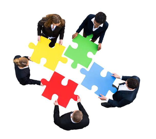 High Angle View Of A Businesspeople Solving Jigsaw Puzzle On White Background - Photo, Image