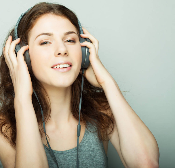 lifestyle and people concept: young woman with headphones listening music. - Photo, image