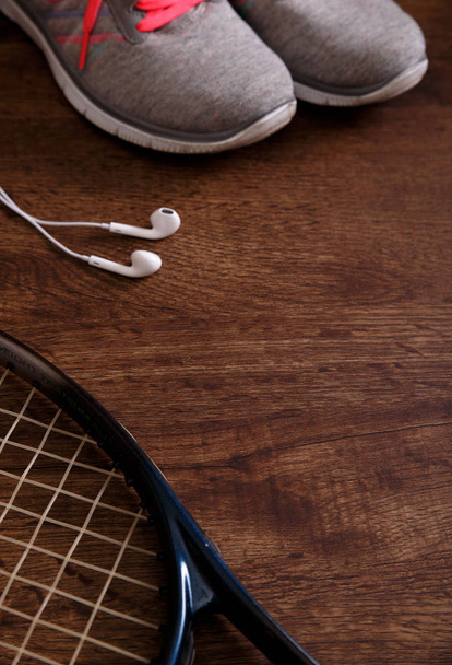 Sneakers, music headphones and tennis racket. - 写真・画像