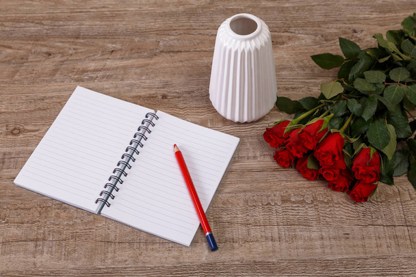 Red roses with pencil and notepad. Love design. - Foto, Bild