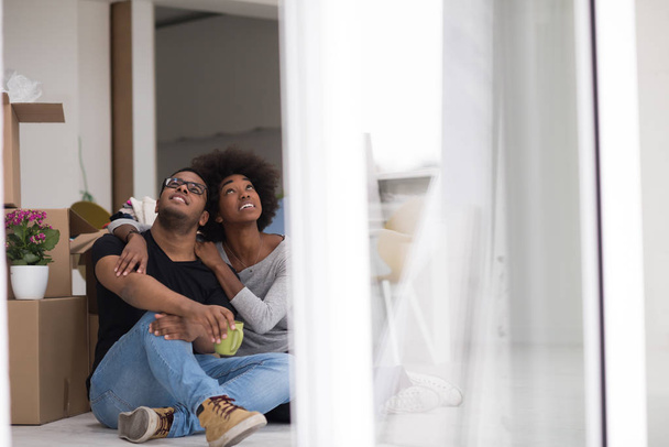 African American couple relaxing in new house - Fotó, kép