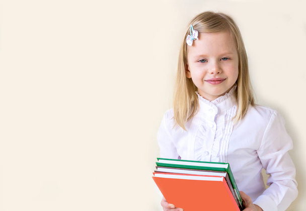 Smart school-age child with books. - Foto, Bild
