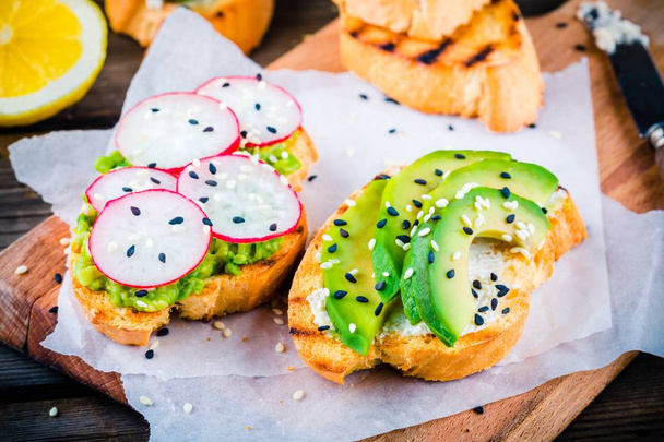 Bread with avocado, radish and sesame - Photo, Image