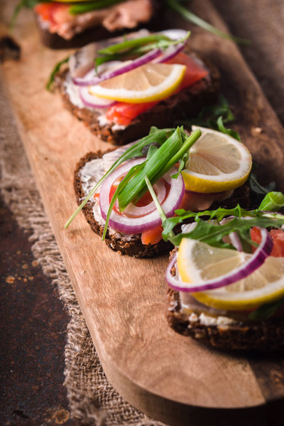 Bread, salmon, herring, onion and lemon closeup - Foto, imagen