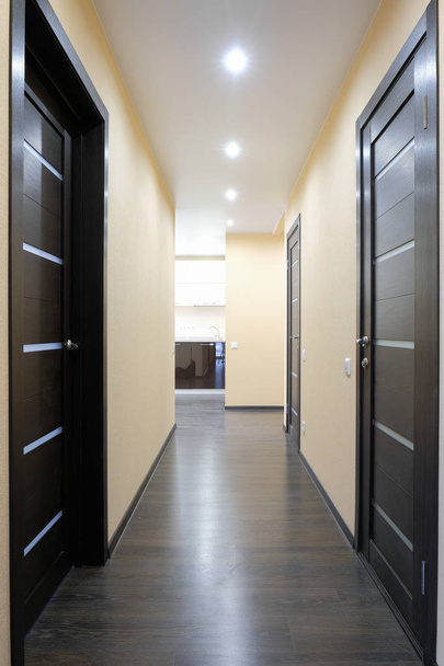 Shot of a corridor with three wooden doors - Фото, изображение