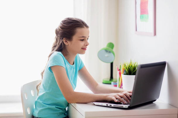 girl typing on laptop at home - Photo, image