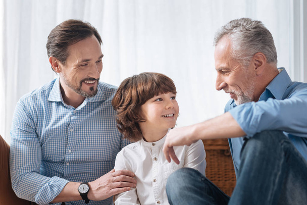Handsome delighted grandfather looking at his grandson - Photo, image