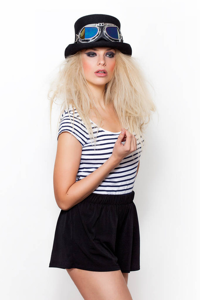 Pretty blonde girl portrait wearing hat and strange sunglasses - Photo, Image