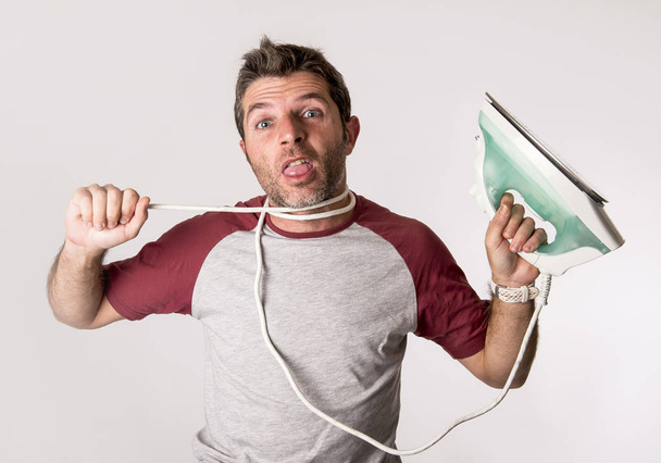 young crazy desperate and frustrated man doing housework holding - Photo, image