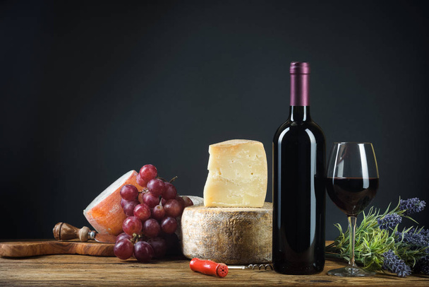 Red wine in vintage light with cheese and fruits. - Fotó, kép