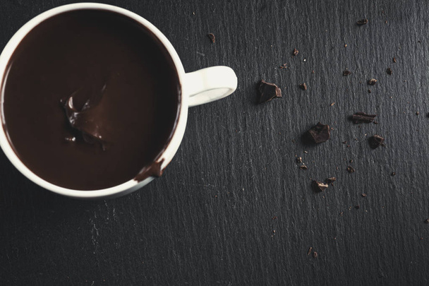 Hot chocolate with bitter chocolate. On a black chalkboard - Φωτογραφία, εικόνα