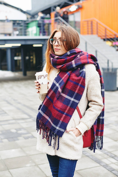 Girl in glasses and blanket scarf with Scottish cell - Photo, Image