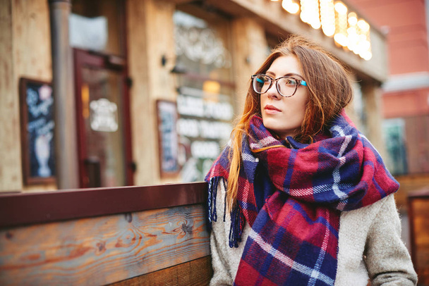 Girl in glasses and blanket scarf with Scottish cell - Photo, Image