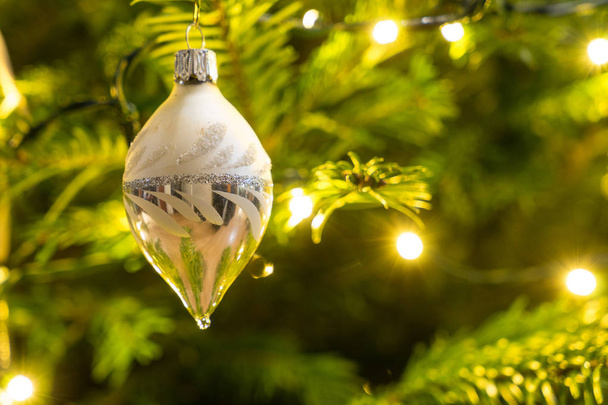 Christmas decoration hanging in a Nordman christmastree close up - Photo, Image