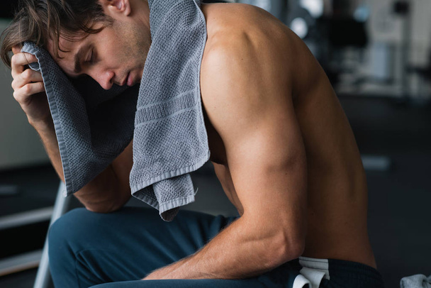 Young man in the gym after a solid workout using his towel - Фото, зображення