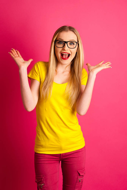 nadšený mladá žena nad růžové pozadí gesto úspěch s ar - Fotografie, Obrázek
