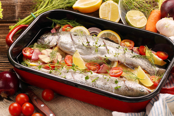 Raw trout with vegetables in a pan ready to bake - Fotografie, Obrázek