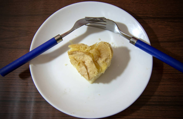Κομμάτι μηλόπιτα με σχήμα καρδιάς και δύο πιρούνια πεπλεγμένη σάρωση σε  - Φωτογραφία, εικόνα