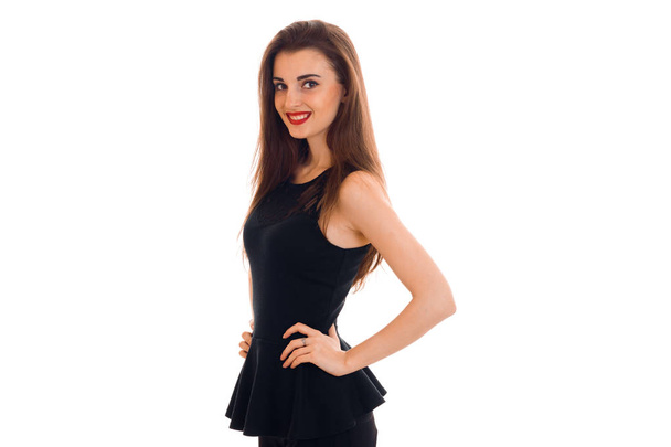 cheerful young lady with red lips in black dress looking at the camera and smiling isolated on white background - 写真・画像