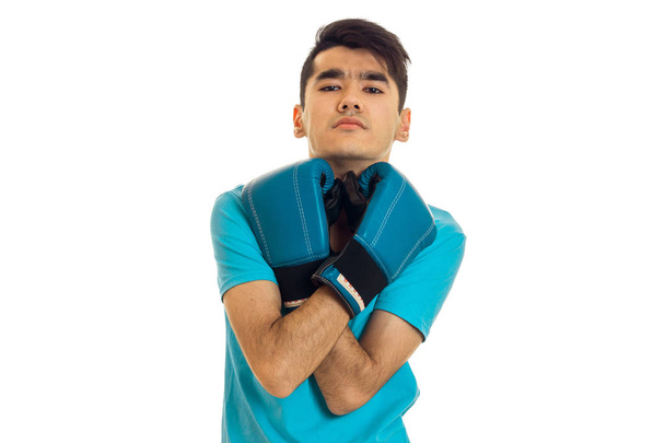 handsome sports man posing in blue boxing gloves in studio isolated on white background - Photo, image