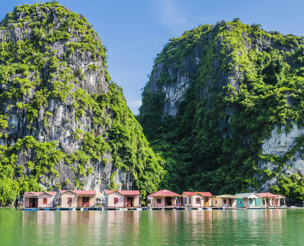 Floating fishing village with rock island in background, Ha Long bay, Vietnam - Photo, Image