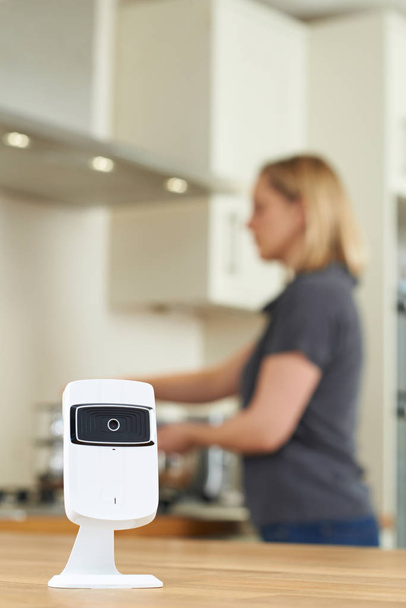 Smart Security Camera In Kitchen As Woman Prepares Meal - Zdjęcie, obraz