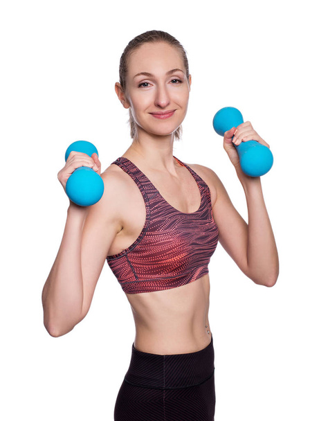 Happy sporty woman with blue dumbbells doing sport exercise. Isolated on white background. - Foto, Imagem